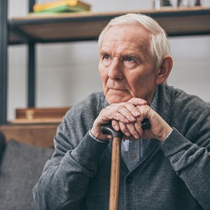 Elderly man wearing sad, serious expression