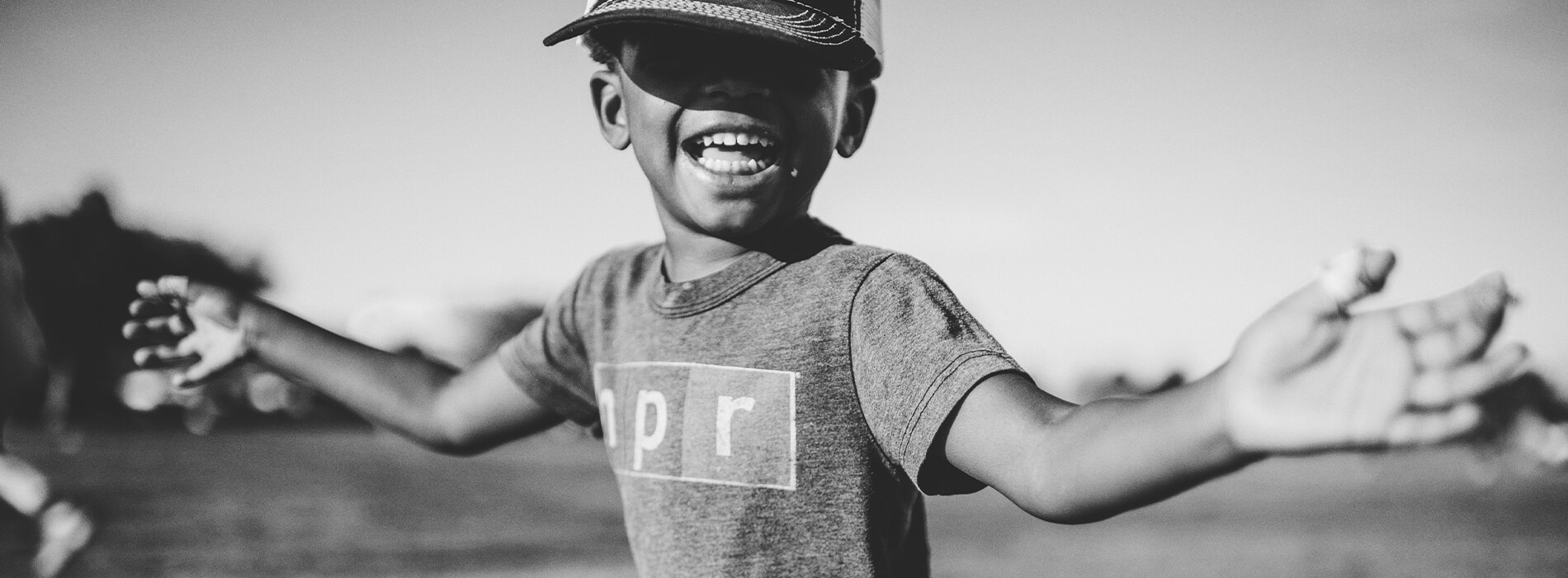Smiling child wearing an N P R shirt
